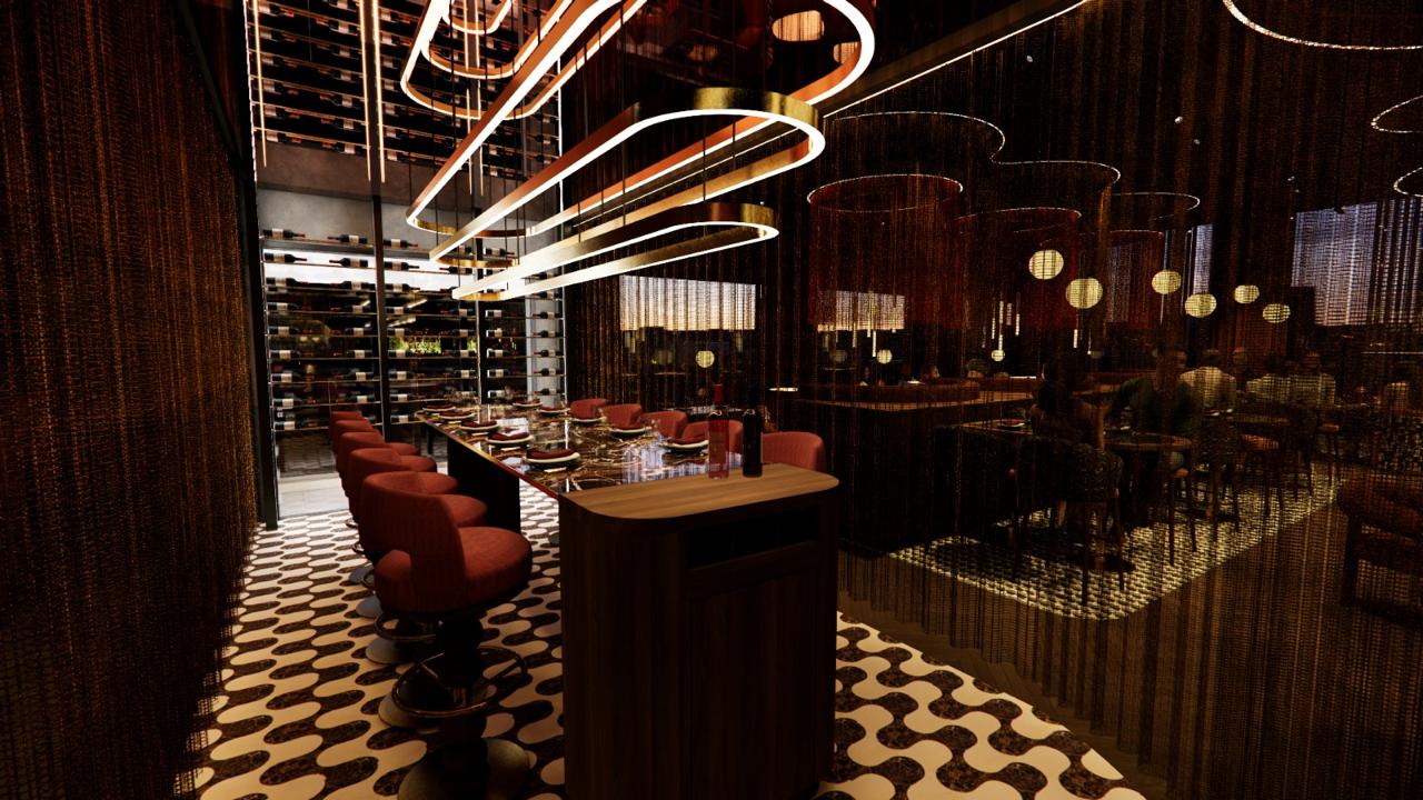 Bar counter detail in brass and stone under pendant lighting.